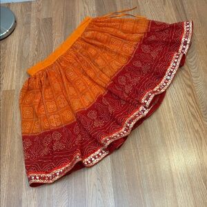 Stylish vibrant orange and red semi-sheer abstract floral circle skirt. Size XL.